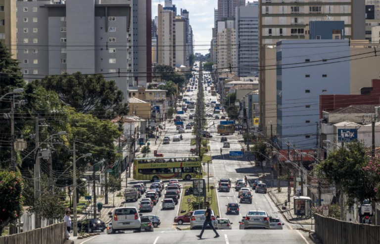 Close up view hand of property realtor giving house keys to new owner after signing contract. Real estate, mortgage and loan Centro de Curitiba